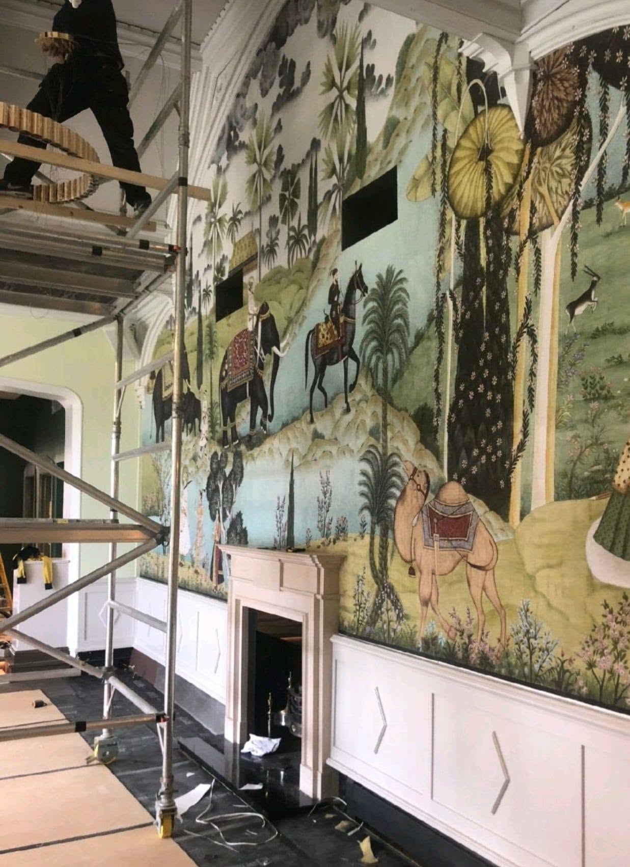Scenic mural wallpaper installation with elephants, camels and palm trees by Essex Decorating Solutions