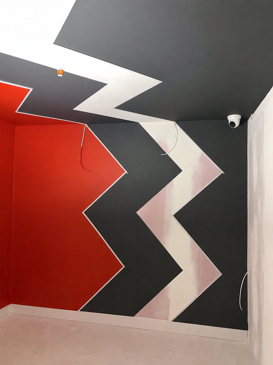 Black and red geometric feature wall decorated by Essex Decorating Solutions in Basildon, Essex